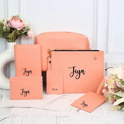 Our complete personalized travel set in a lovely peach color. This 6-piece combo includes a passport cover, luggage tag, card holder, phone card holder, utility pouch, and a larger pouch.