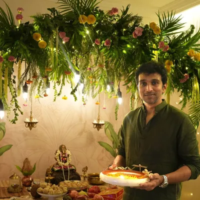 We were honored to create this Ganpati celebration space for actor Pratik Gandhi. The decor features a stunning overhead installation of dense greenery, florals, and hanging lights, providing a beautiful and blessed setting for the festivities.