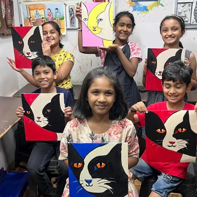 A group of our talented young students showing off their finished cat canvas paintings. It's wonderful to see how each child used the same instructions to create a unique piece of art.
