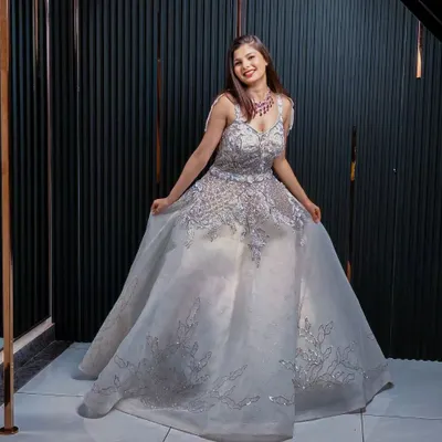This stunning silver ball gown is perfect for a reception or engagement party. The intricate silver embroidery and voluminous skirt create a look of pure glamour, ensuring you feel like royalty.