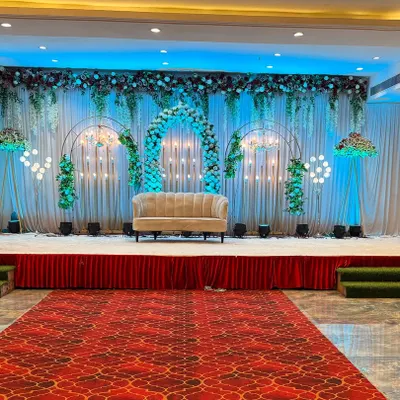 A beautiful and modern stage decoration at Sky banquet hall in Kharghar. The combination of green and white florals with elegant lighting creates a fresh and sophisticated look.
