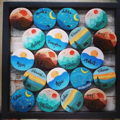 A full tray of our custom travel-themed magnets, created as birthday return gifts. Each one is a tiny, hand-painted world, from starry nights to mountain sunrises.