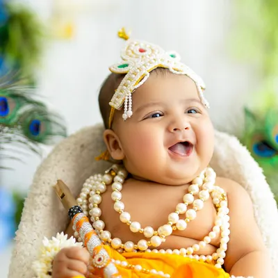 The most joyful, heartwarming smile from a baby Krishna. This close-up captures the pure happiness and divine charm of our festive Janmashtami sessions.