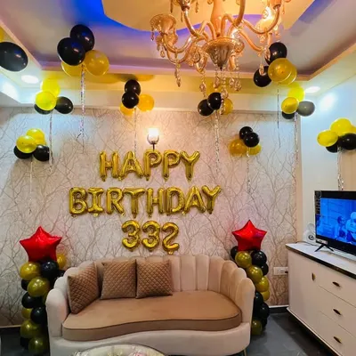 A simple yet festive birthday decoration for a living room. I used gold foil "Happy Birthday" balloons as the main feature, with black and yellow balloon clusters to fill the space.