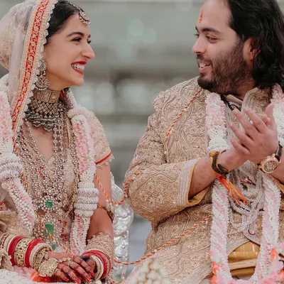 A candid moment of shared smiles between Radhika and Anant during their wedding ceremony. It's these genuine interactions, full of warmth and affection, that we feel most privileged to witness and preserve.