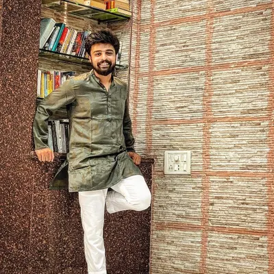 A quiet moment at home. This is me in my element, surrounded by books and wearing traditional Indian attire.