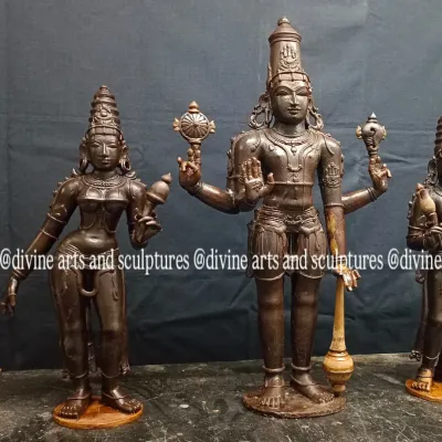 A view of the customized wax models for a Ranganathar set, featuring Lord Vishnu flanked by his consorts, Sridevi and Bhoodevi. The initial waxwork establishes the posture, adornments, and divine expression of each figure.
