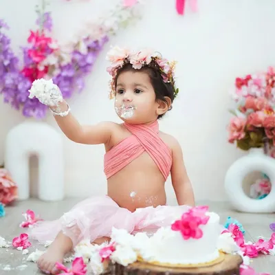 This is what a first birthday is all about! This little girl is enjoying every bit of her cake smash, and I'm here to capture all the messy fun.