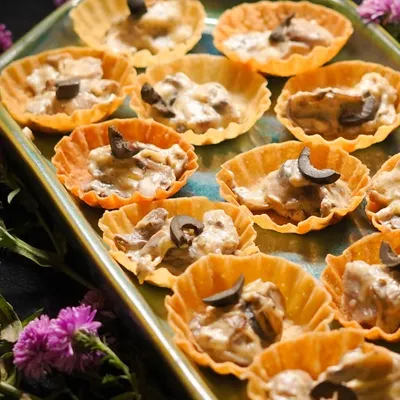 My Creamy Mushroom Tarts are a vegetarian delight. A rich, savory mushroom filling is served in a crispy tart shell and topped with an olive for a touch of saltiness.