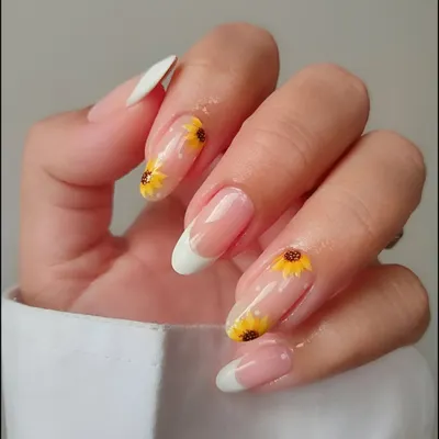 Learn the art of delicate, hand-painted designs. Here, our student created a beautiful French manicure with detailed sunflower accents, a perfect example of the precision painting skills we teach.