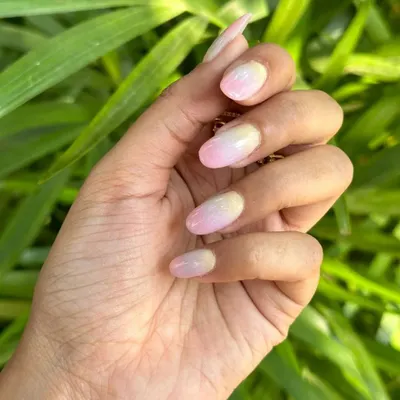 A soft and pretty ombré effect blending from a pale yellow at the cuticle to a gentle pink at the tip. This gradient creates a subtle, sun-kissed look.