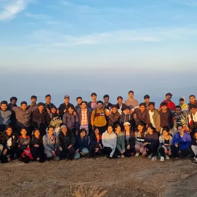 A large group of over 50 college students posing for a photo at the summit. We specialize in organizing large-scale outdoor leadership programs for educational institutions.
