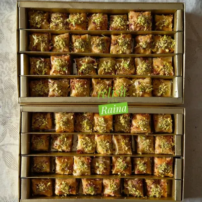 Two boxes of my square-cut Baklava, ready for a customer. This sweet is perfect for gifting or for treating yourself, with its nutty aroma and crisp texture.