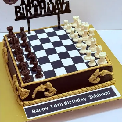 A checkmate-worthy chess theme cake for a 14th birthday. The board is an edible print, and all the chess pieces are hand-molded from chocolate, combining a love for the game with a love for cake.