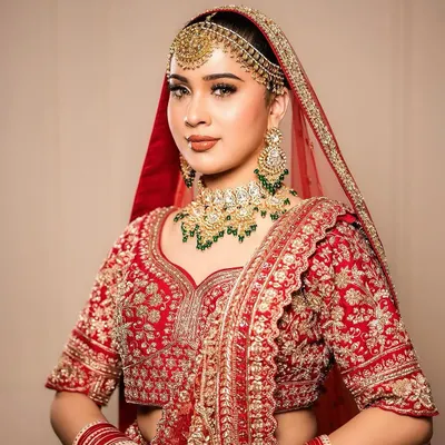 A classic bridal portrait showcasing a traditional red lehenga with our signature makeup. We focused on defined eyes and a balanced complexion to complement the rich tones of the outfit and heavy jewelry.