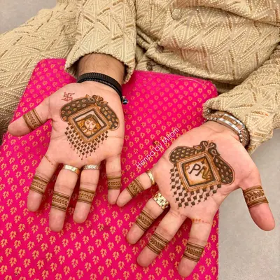 Grooms deserve special mehendi too. This is a custom design for the groom, featuring his and his partner's initials along with a fun portrait, making it a memorable part of the wedding festivities.