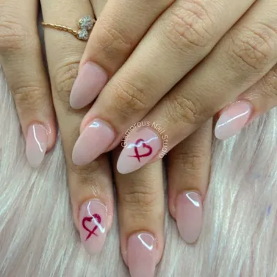 Sometimes, less is more. This beautiful set features a clean, semi-sheer nude base on a classic almond shape, with a single, delicately painted heart on the accent nails. It's the definition of simple and sweet.