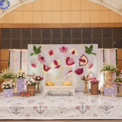 The full stage for a beautiful Godh Bharai, or traditional baby shower. We used a lotus theme with floral art, traditional brass vases, and a custom printed floor.