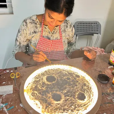Our moon lamp workshop is a truly unique experience. A guest is seen here adding texture and paint to create a realistic moon surface that glows beautifully.