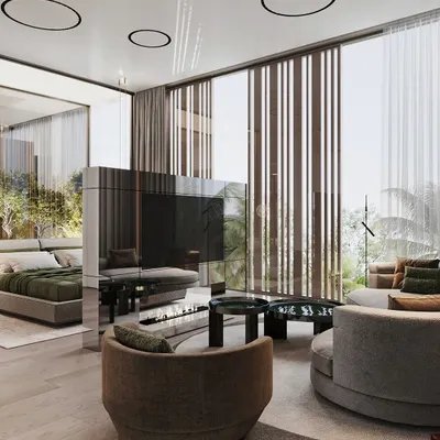 This master suite is designed as a multi-functional retreat, with a distinct seating area for relaxation. The centerpiece is a custom-made, mirrored, rotatable TV unit that elegantly divides the sleeping and lounging zones.