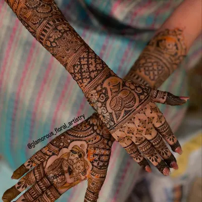 A complete view of bride Namratha's stunning bridal mehendi, featuring a couple portrait on one palm and a traditional kalash on the other, surrounded by intricate patterns.