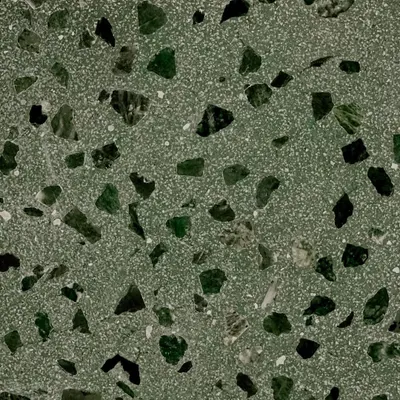 A close-up of our new terrazzo in a beautiful olive green. The mix of green and black stone chips creates a rich, earthy texture perfect for a unique tabletop or surface.