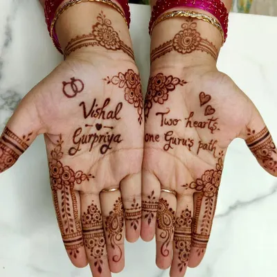 A personalized engagement mehendi for Gurpriya, featuring the couple's names, "Vishal & Gurpriya," and interlocking rings.