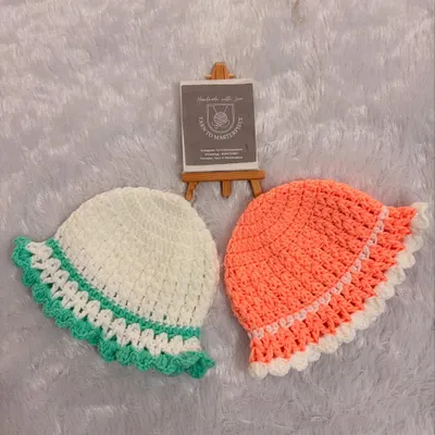 These cute, bucket-style baby hats are perfect for sunny days. I make them in a variety of colors with a sweet, ruffled brim.