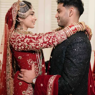 A beautiful moment of connection between the bride and groom after their Nikaah. The bride's arms wrapped around her husband shows a lovely, intimate connection.