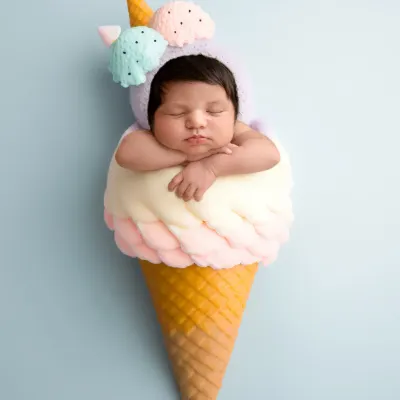 Sweet as can be! This newborn is dressed as a scoop of ice cream in this fun, creative, and completely safe composite image.