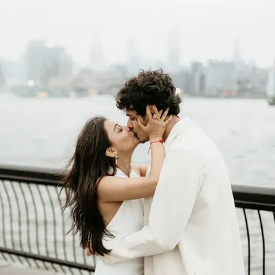 An intimate kiss with the New York City skyline softly blurred in the background. This destination pre-wedding photo focuses on the couple's connection while still capturing the essence of the city.