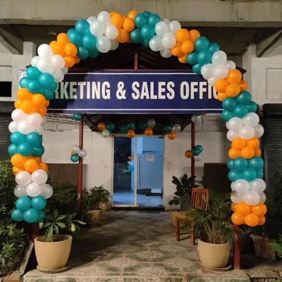 A full balloon arch in a tricolor theme for a Marketing & Sales Office grand opening. This setup creates a bold and professional entrance to attract clients.