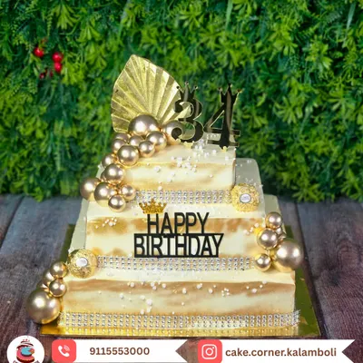 A grand three-tier square cake for a 34th birthday. The white and gold design with pearl details and metallic spheres is the definition of luxury and elegance.