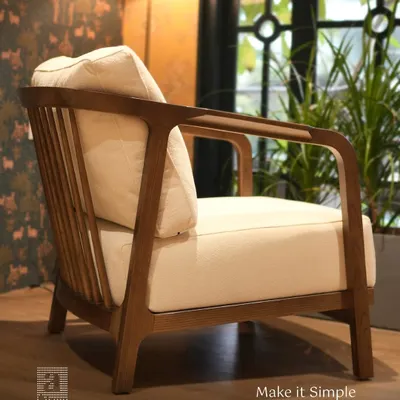 This armchair showcases my minimalist design philosophy. Crafted with a solid teak wood frame and plush cream cushions, it offers significant comfort and timeless style.