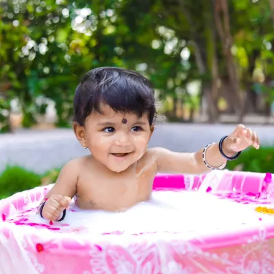 A joyful milk bath session to celebrate a baby's milestone. I love creating these unique, fun setups outdoors, using natural light to capture pure, happy expressions.