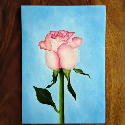 A realistic pink rose painted with oils on A5 paper. Oil paints allow for beautiful, smooth blending, which is perfect for capturing the soft texture of flower petals.