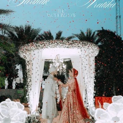 The pinnacle of the ceremony, the Varmala exchange. We capture this moment with a sense of grandeur, complete with a shower of petals and the beautiful floral mandap at Sarthak and Vratika's wedding.