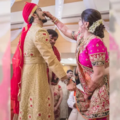 A heartwarming moment from a pre-wedding ritual, where the groom's mother lovingly feeds him. These are the family moments that I strive to capture with authenticity.