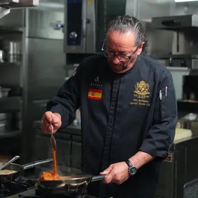 In the kitchen, where I feel most at home. Here I am, stirring a sauce, ensuring the flavors are just right. This is my passion.