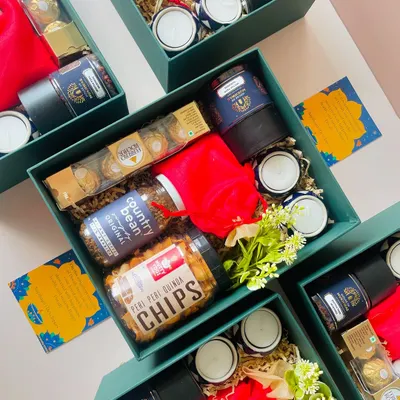 These beautiful teal green boxes were curated for Diwali. Each one is filled with gourmet snacks like quinoa chips and country bean coffee, Ferrero Rocher, and scented candles.