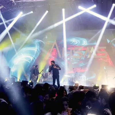 I am experienced in capturing large-scale events with complex stage lighting, like this Sangeet featuring a live band performance. I make sure to get shots of the performers, the crowd, and the overall electrifying atmosphere.
