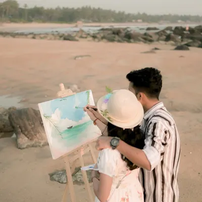 A creative pre-wedding shoot idea: painting the scenery together on a beach in Mangaluru. This is a wonderful way to capture a shared activity.