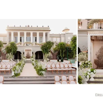 A soft sunrise wedding with a view. We designed this elegant ceremony with Mahal-style guest seating and a sculptural floral tree as the focal point, all in a pristine palette of whites and greens against the palace backdrop.