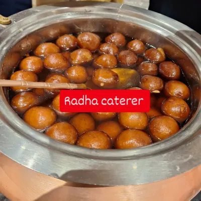 A large pot of our signature Gulab Jamuns, soaking in warm sugar syrup. This is a must-have dessert for any celebration.