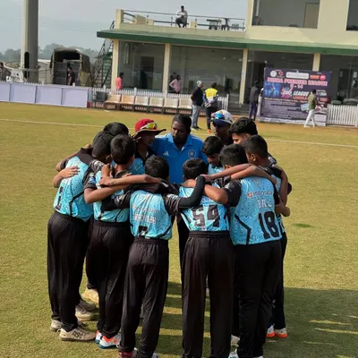 The team in a tight huddle, listening intently to the coach's final words of motivation before taking the field. This is where the game plan is set.