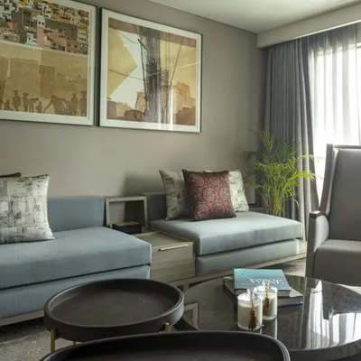 The family lounge at the Jor Bagh Residence, where modern aesthetics meet comfort. The space is carefully crafted with custom low-slung sofas and contemporary art to create a harmonious and visually striking home.