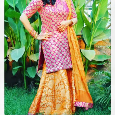 This brocade sharara suit is a wonderful choice for festive family gatherings. The combination of pink and orange is classic and joyful, and the rich fabric gives the outfit a luxurious feel without being overly heavy.