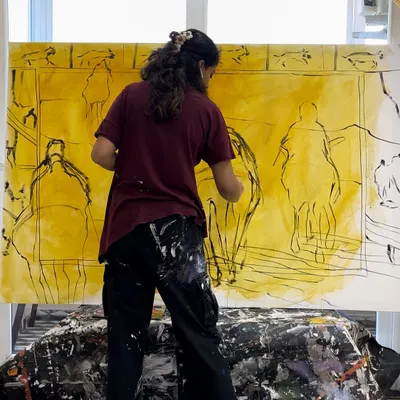 Me in my element, working on a large-scale canvas. The initial stages often involve loose sketches and laying down the first layers of color to map out the composition.