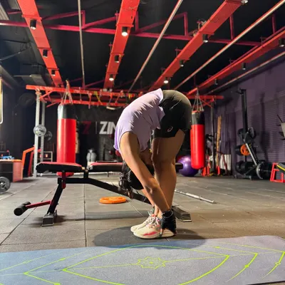 A deep forward fold stretch after a workout. Flexibility is key to preventing injuries and improving your dance movements, so we always make time for a proper cool-down.