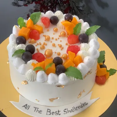 A fresh and delicious fruit cake. This cake is topped with a generous amount of fresh mango, grapes, and watermelon, perfect for someone who loves a lighter dessert.